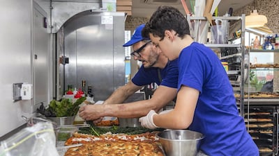 Preparing pizza in pre-pandemic times. Photo by Grace Guino