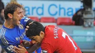 Luis Suarez, right, has bitten three players on the pitch, including Chelsea’s Branislav Ivanovic, but Barcelona do not fear a repeat. Andrew Yates / AFP