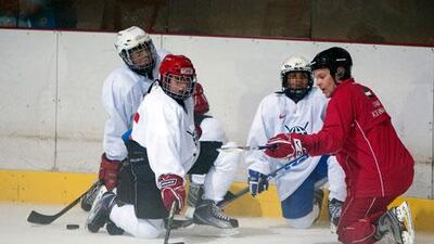 Matti Fagerstrom, in red, is coaching players at grass-roots level, including in the Under 20 Emirates Hockey League.