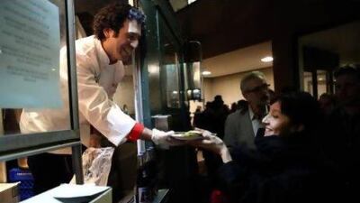 Michael Rakowitz serves food at Enemy Kitchen, 2006, an installation that is part of the art project Feast: Radical Hospitality in Contemporary Art at the Smart Museum of Art in Chicago. Courtesy Michael Rakowitz and Lombard Freid Gallery