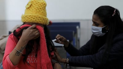 A woman receives a dose of the Covishield vaccine against the coronavirus at a centre in New Delhi, India. Reuters