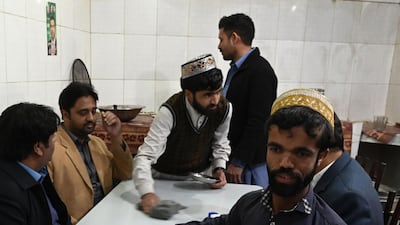 Rozi Khan serves food to customers at Dilbar Hotel in Rawalpindi. AFP