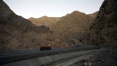 A water tanker travels along the Jebel Jais mountain path known as the 'Road to Nowhere' in the Hajjar Mountains near Ras al Khaimah.