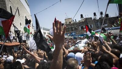 People carry the body of Muhammad Abu Kdear during his funeral ceremony in Jerusalem, Israel. Muhammad is thought to have been murdered earlier this week in revenge to the killing of the three Israeli teenagers two weeks ago in the West-bank. Ilia Yefimovich / Getty Images