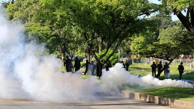 Venezuelan Bolivarian National Guard officers fire teargas towards a resident trying to walk to the Paramacay military base in Valencia, Venezuela's third city, on August 6, 2017. Juan Carlos Hernandez / AP