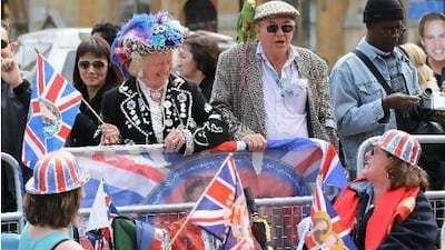 Spectators hoping to catch a glimpse of Prince William and Kate Middleton camp out along the procession route a day ahead of the Royal Wedding in London, England.