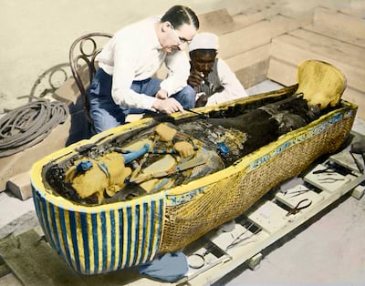 Archaeologist Howard Carter and an Egyptian assistant examine the sarcophagus of King Tutankhamen in 1922. AFP