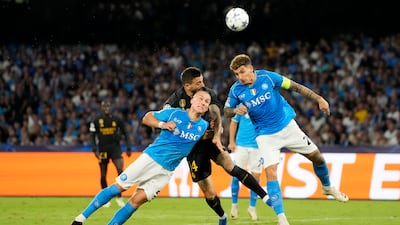 Napoli's Giovanni Di Lorenzo, right, and Napoli's Leo Ostigard, left, challenge Real Madrid's Joselu. AP