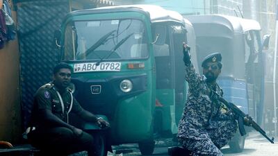 Security personnel react as a device is detonated in a controlled explosion in a van near St Anthony's Church. EPA