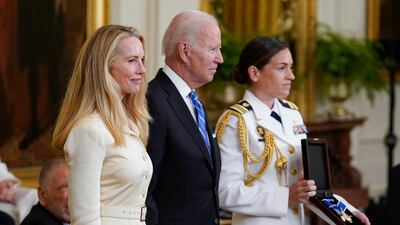Mr Biden stands with Laurene Powell Jobs as he awards the Presidential Medal of Freedom to Apple co-founder Steve Jobs, her late husband. AP