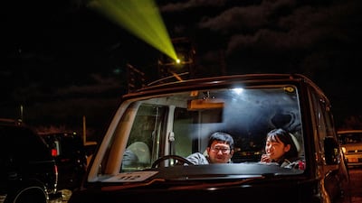 Visitors sit inside their cars at a drive-in cinema at Nagai Seaside Park in Yokosuka, Kanagawa prefecture, south of Tokyo. AFP