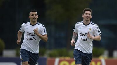 Argentina’s forward Lionel Messi (R) and forward Sergio Aguero jog during a training session in Ezeiza, Buenos Aires on March 21, 2016 ahead of a 2018 FIFA World Cup Russia South American qualifier football match against Chile to be held in Santiago on March 24. AFP PHOTO / JUAN MABROMATA