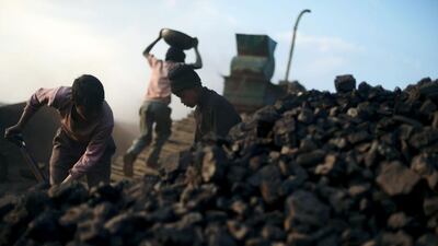 Children carry baskets of coal at a roadside depot in the East Jaintia Hills district of Meghalaya in India’s north-eastern. Roberto Schmidt / AFP / January 30, 2013
