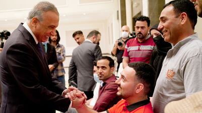 Iraqi Prime Minister Mustafa Al Kadhimi greets protesters who were injured in demonstrations that began in October 2019, before they left for medical treatment in Germany Photo: Iraqi Prime Minister Media Office