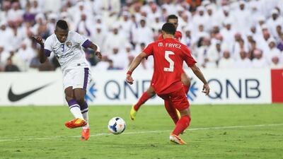 Asamoah Gyan, left, scores his first of two goals in the Asian Champions League game at Hazza bin Zayed Stadium on May 13 , 2014, to lift Al Ain over Al Jazira. Delores Johnson / The National