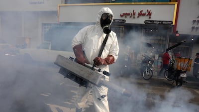 A firefighter disinfects a square against the new coronavirus, in western Tehran, Iran, Friday, March 13, 2020. The new coronavirus outbreak has reached Iran's top officials, with its senior vice president, Cabinet ministers, members of parliament, Revolutionary Guard members and Health Ministry officials among those infected. The vast majority of people recover from the new coronavirus. According to the World Health Organization, most people recover in about two to six weeks, depending on the severity of the illness. (AP Photo/Vahid Salemi)