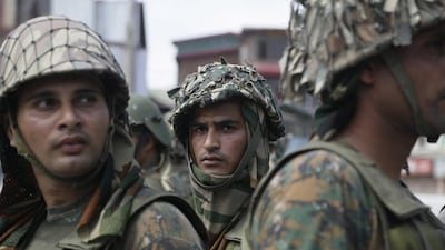 Paramilitary guard the site of a gun-battle in the Nowhatta neighborhood of Srinagar. Mukhtar Khan / AP Photo