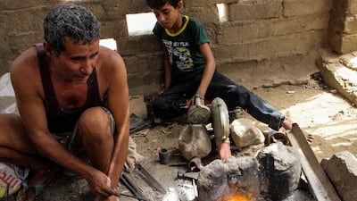 Yemenis burn wood to create a fire for the forge.