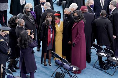 Poet Amanda Gorman takes a photo with former president Barack Obama and Michelle Obama. Reuters