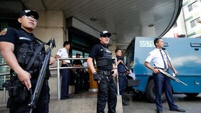 Members of the Philippine national police Swat team patrol a bank in Manila on Friday. Bullit Marquez / AP Photo