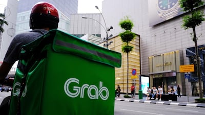 A Grab food delivery driver waits for an order in the Bukit Bintang district of Kuala Lumpur, Malaysia. The Singapore-based ride hailing company has just raised $856m to move into the financial services market. Bloomberg