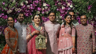 (L-R) Radhika Merchant, Anant Ambani, Nita Ambani, Akash Ambani, Isha Piramal, Anand Piramal and Mukesh Ambani, the Chairman of Reliance Industries. Photo: Reuters