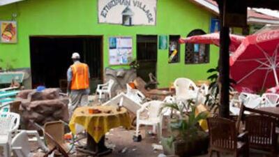 An investigator walks through the remains of an Ethiopian-themed restaurant that was hit by an explosion in Kampala.