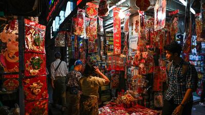 Customers look at decorations at a street market in Yangon's Chinatown district in Myanmar. AFP