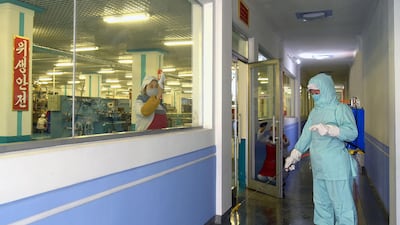 An employee sprays sanitiser at the Pyongyang Dental Hygiene Products Factory in Pyongyang. Korean Central News Agency (KCNA) / AFP