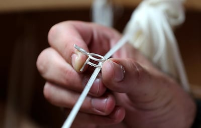 Polishing is done using soft cotton threads coated with grained abrasive pastes. Pawan Singh / The National