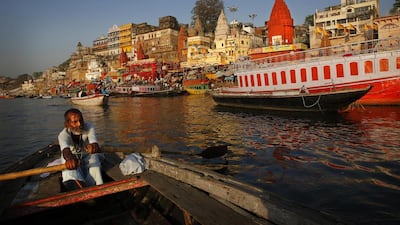 An Indian boatman rows past some of the many ghats that line the banks of the River Ganges in the city of Varanasi. Manish Swarup / AP Photo