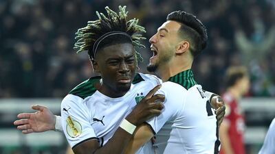 Moenchengladbach's French midfielder Kouadio Kone (L) celebrates scoring the opening goal with his teammate Ramy Bensebaini during the 5-0 German Cup win against Bayern Munich. AFP