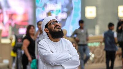 Passersby check out the damage sustained to The Address Hotel.