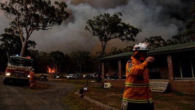 Rural Fire Service (RFS) firefighters conduct property protection near the town of Sussex Inlet in Sydney, Australia. Getty