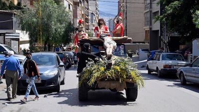 A man displays a statue of Jesus Christ on his vehicl as he drives in a Christian neighborhood of Ain Remmaneh on the eve of Good Friday in Beirut, Lebanon. EPA