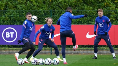 England's Phil Foden, left, and Conor Gallagher battle for the ball during a training session at Hotspur Way Training Ground. PA