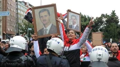 Syrians who support President Bashar Al Assad demonstrate outside the "Friends of Syria" meeting in Istanbul where foreign ministers from dozens of countries gathered to discuss the violence in Syria.