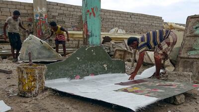 Craftsmen work at a traditional fishing boat construction site in Yemen's port city of Hodeidah. AFP
