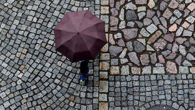 A pedestrian walks during the rainy day in Dresden, Germany. EPA
