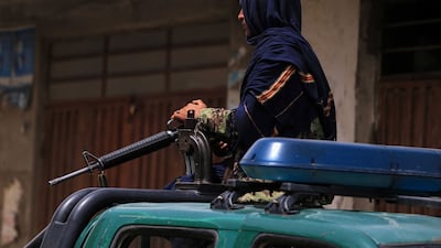 A Taliban stands guard outside a school in the aftermath of multiple bomb blasts, in a Shi'ite majority neighborhood, in Kabul, Afghanistan. EPA