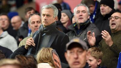 A supporter holds a Jose Mourinho cut-out in the stands during the Premier League match against Stoke City on Saturday. Paul Ellis / AFP / November 7, 2015