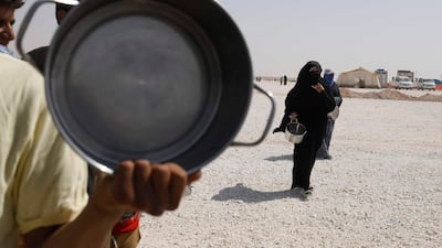 Displaced Syrians queue up to receive food at Al Mabrouka camp in the village of Ras Al Ain on the Syria-Turkey border on August 24, 2017. Delil Souleiman