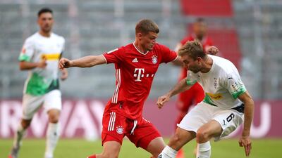 Bayern Munich's Mickael Cuisance is challenged by Christoph Kramer of Borussia Monchengladbach. EPA