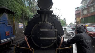 A railway worker carrying out maintenance on the steam engine. Finding spares parts for the century-old engine is a problem say officials