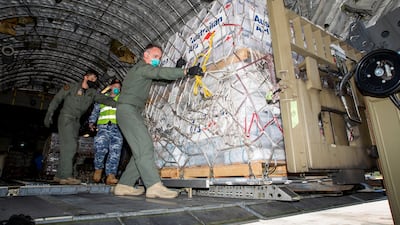 Australian Defence Forces members unload humanitarian assistance and engineering equipment from an aircraft at Fua'amotu International Airport, Tonga. Australian Department of Defence / Handout via Reuters