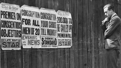 A man studying newspaper notices about conscription in 1939 at the outbreak of World War II