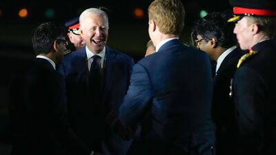 Mr Biden smiles after stepping off Air Force One in Belfast. AP