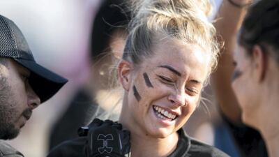 DUBAI, UNITED ARAB EMIRATES - DECEMBER 7, 2018. A woman gets her face painted before partaking in the Tough Mudder challenge in Hamdan Sports Complex. du Tough Mudder is a mud and obstacle course designed to test participant's physical strength, stamina, and mental grit. It is a team-oriented challenge with no winners, finisher medals, or clocks to race against. (Photo by Reem Mohammed/The National) Reporter: Section: NA