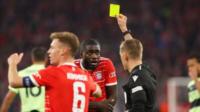 Dayot Upamecano of Bayern Munich is shown a yellow card after a handball that resulted in a penalty for Manchester City. Getty