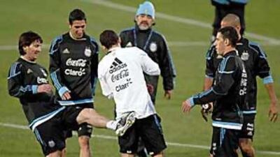 Lionel Messi gives Javier Mascherano, Argentina's captain, a playful kick during practice.